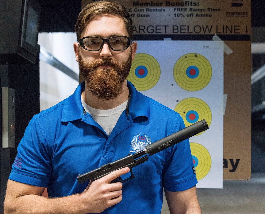 In this photo taken Jan. 27, 2017, Knox Williams, president and executive director of the Georgia-based American Suppressor Association, poses for a portrait while holding a handgun with a silencer, In Atlanta. They are the stuff of legend, wielded by hit men and by James Bond. For decades, buying a silencer for a firearm has been as difficult as buying a machine gun, requiring a background check that can take close to a year. Now, emboldened by the election of Donald Trump as president, the industry has renewed a push in Congress to ease those restrictions, arguing that it’ll help preserve the hearing of gun users. (AP Photo/Lisa Marie Pane)
