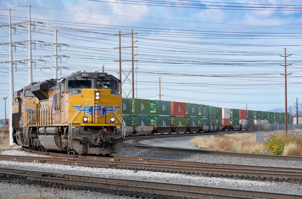 (Francisco Kjolseth | The Salt Lake Tribune) Shipping containers are moved by rail in and out of the Union Pacific intermodal terminal at a steady pace, west of Salt Lake City. Directly south is the future site of the transloading facility, which will be the heart of the inland port, as seen on Wednesday, Nov. 10, 2021.
