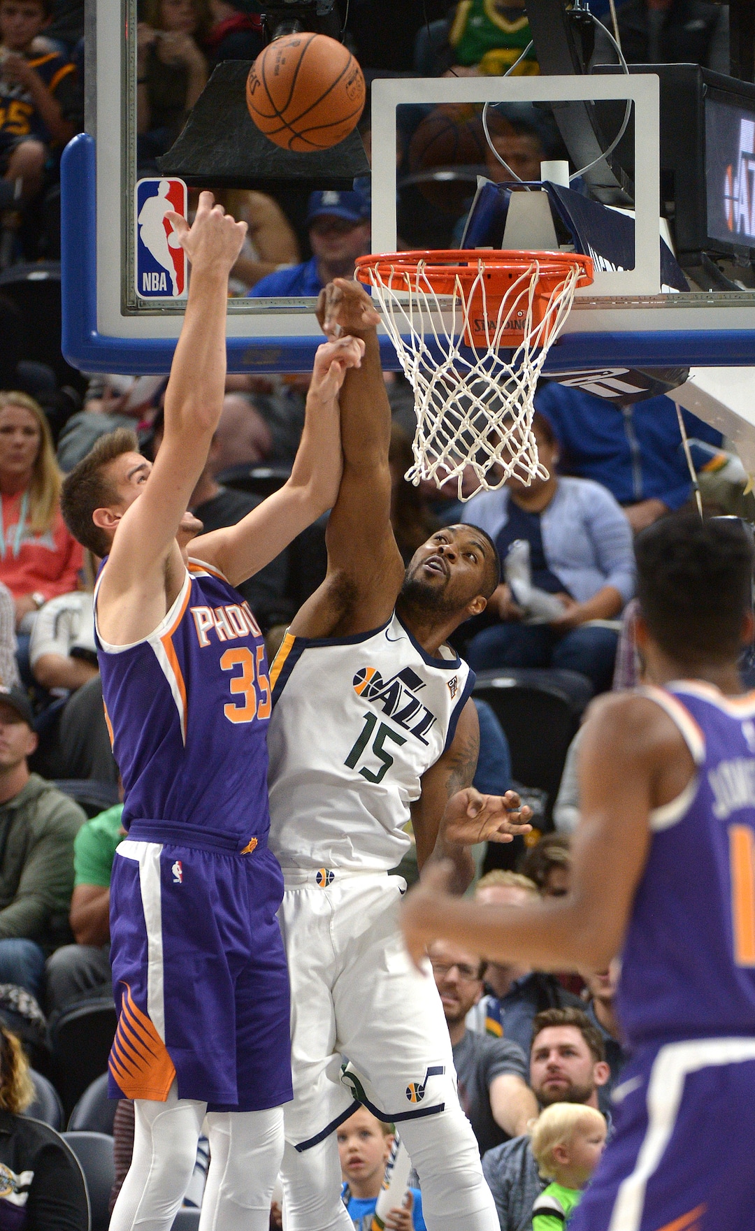 (Leah Hogsten  |  The Salt Lake Tribune)  Utah Jazz forward Derrick Favors (15) blocks Phoenix Suns forward Dragan Bender (35). The Utah Jazz defeated the Phoenix Suns 112-101 during preseason NBA basketball at Vivint Smart Home Arena in Salt Lake City, October 6, 2017.