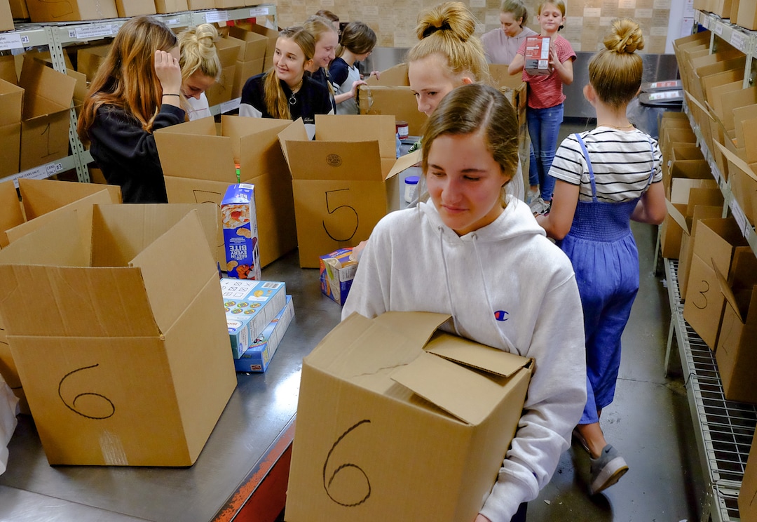 (Francisco Kjolseth  |  The Salt Lake Tribune) Kate Larsen, 15, spends her birthday with friends helping out at The Utah Food Bank on Saturday, March 14, 2020, after hearing they are hurting for volunteers, since groups that normally volunteer canceled after the order of mass gatherings due to the coronavirus outbreak.