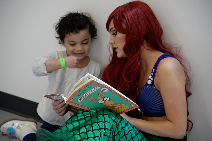 (Francisco Kjolseth  |  The Salt Lake Tribune) Whitney Gillman dressed as Ariel reads a dental related children's book to a young patient before they get no-cost dental work at the University of Utah dental school on Saturday, Feb. 29, 2020, as part of the American Dental AssociationÕs ÒGive Kids a SmileÓ program.