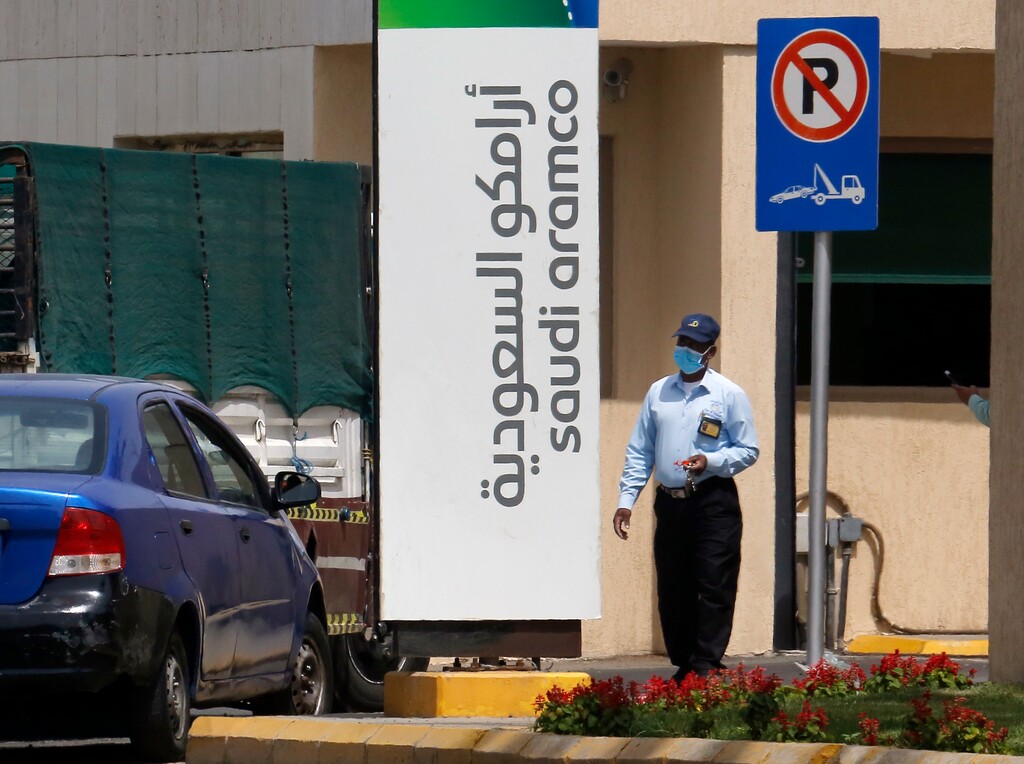 (Amr Nabil | AP) A security person wears a mask as he checks vehicles entering a compound for Saudi Aramco in Jiddah, Saudi Arabia, Monday, March 9, 2020. State oil giant Saudi Aramco sees shares drop by 10% as Riyadh stock market opens, halting trading.