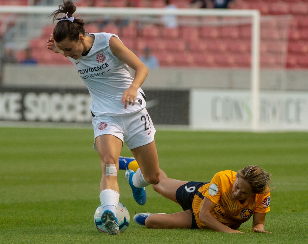 (Rick Egan  |  The Salt Lake Tribune)    Utah Royals FC midfielder Lo'eau LaBonta (9) hits the ground after colliding with Portland Thorns FC defender Elizabeth Ball (27), in Soccer action between Utah Royals FC and Portland Thorns FC, in Sandy, Friday, July 19, 2019.