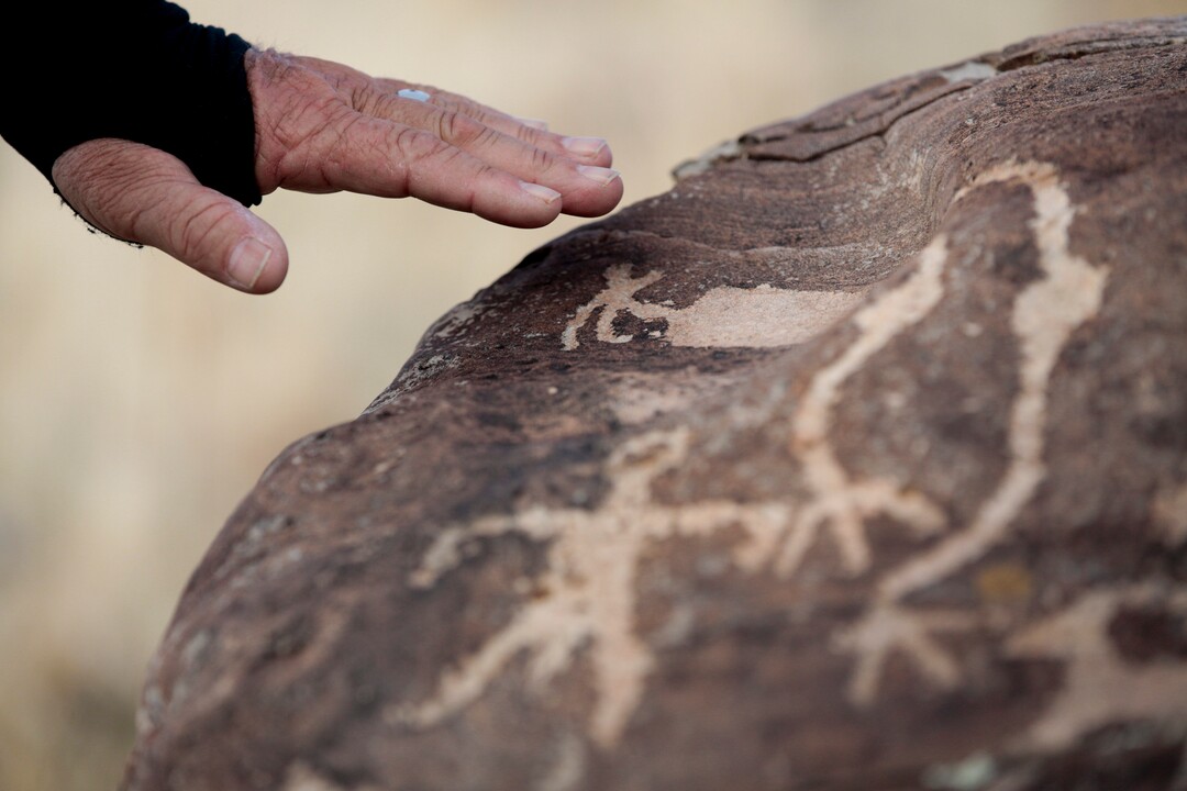 Steven Acerson, the president of the Utah Rock Art Research Association, talks about the rock art on a boulder on Thursday, Feb. 8, 2018, in the West Mountain area of Utah. (Evan Cobb/The Daily Herald via AP)