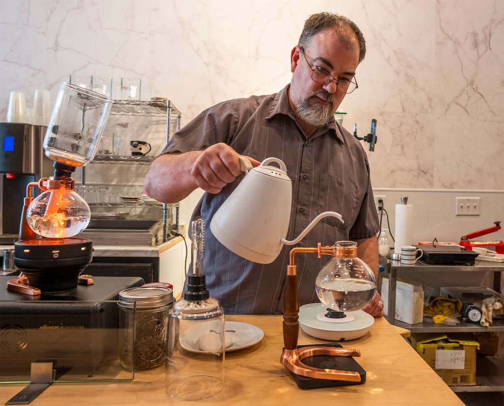 (Rick Egan | The Salt Lake Tribune)  John Piquet brews coffee using the siphon brewing process at Caffe d'Bolla, on Tuesday, Sept. 19, 2023.