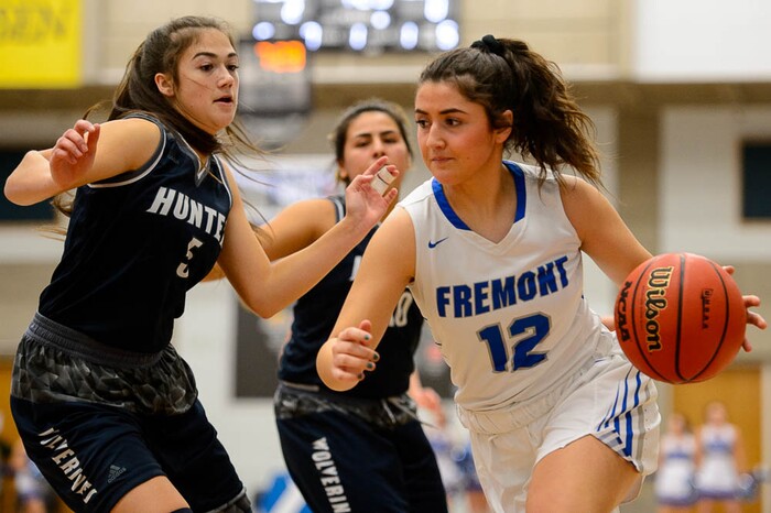 (Trent Nelson | The Salt Lake Tribune)  Fremont's Abby Broadbent (12) drives on Hunter's Tanzie Gasu (5) as Hunter faces Fremont in the 6A High School Girls' Basketball Tournament at SLCC in Taylorsville, Tuesday Feb. 20, 2018.