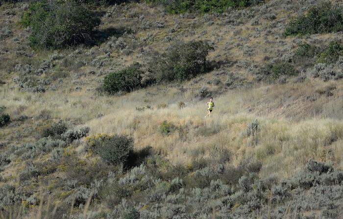 (Scott Sommerdorf | The Salt Lake Tribune) Reed Muir proves it's lonely at the front, as he crushes the field to win the Heber Creeper train 12k race. The runners raced toward the finish line near the Soldier Hollow train station after starting at the Deer Creek Dam, Saturday, August 19, 2017.