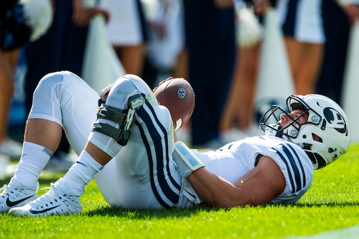 (Chris Detrick  |  The Salt Lake Tribune)  Brigham Young Cougars quarterback Beau Hoge (7) remains on the ground after being tackled for a safety by Wisconsin Badgers linebacker Tyler Johnson (59) during the game at LaVell Edwards Stadium Saturday Saturday, September 16, 2017. Wisconsin Badgers defeated Brigham Young Cougars 40-6.