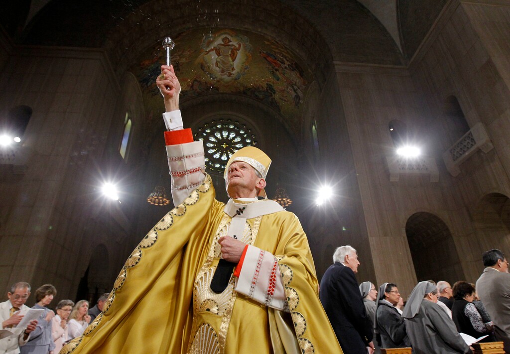 FILE - In this Sunday, April 24, 2011 file photo, Cardinal Donald Wuerl, Archbishop of Washington, sprinkles Holy Water during Easter Mass at the Basilica of the National Shrine of the Immaculate Conception Roman Catholic Church in Washington. On Tuesday, Aug. 15, 2018, a Pennsylvania grand jury accused Cardinal Wuerl of helping to protect abusive priests when he was Pittsburgh's bishop. (AP Photo/Alex Brandon)