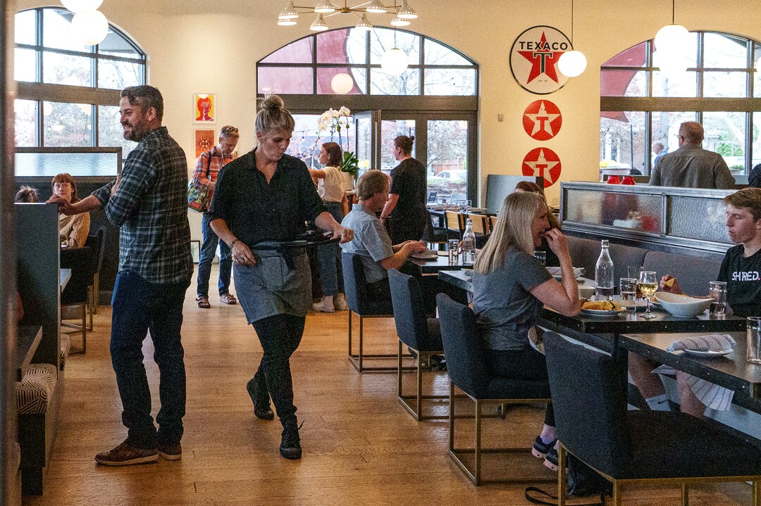 (Leah Hogsten | The Salt Lake Tribune) Emigration Cafe co-owner Scott Evans, left, greets diners during the restaurant's opening night, Wednesday, April 27, 2022. Emigration Cafe's menu features Roman style wood fired pizza, salads, sandwiches and mains.