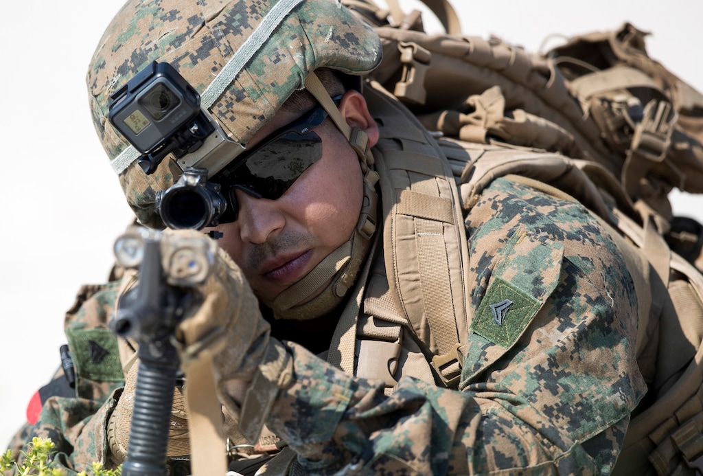 A U.S. marine takes a part in a landing operation during military Exercise Baltops 2018 at the Baltic Sea near village Nemirseta in Klaipeda district, some 340 kms (211 miles) west north of the capital Vilnius, Lithuania. Lithuania, Monday, June 4, 2018. A major U.S.-led military exercise with 18,000 soldiers from 19 primarily NATO countries has kicked off in the alliance's eastern flank involving Poland and the three Baltic states of Estonia, Latvia, Lithuania. (AP Photo/Mindaugas Kulbis)