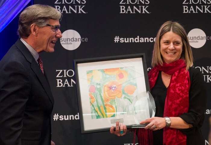 (Rick Egan  |  The Salt Lake Tribune)    Carrie Romano, CEO of the Intermountain Ronald McDonald House, receives a leadership award from Scott Anderson, president and CEO of Zions Bank, at the 2018 Sundance Film Festival Utah Women’s Leadership Celebration in Park City on Thursday, Jan. 25, 2018.