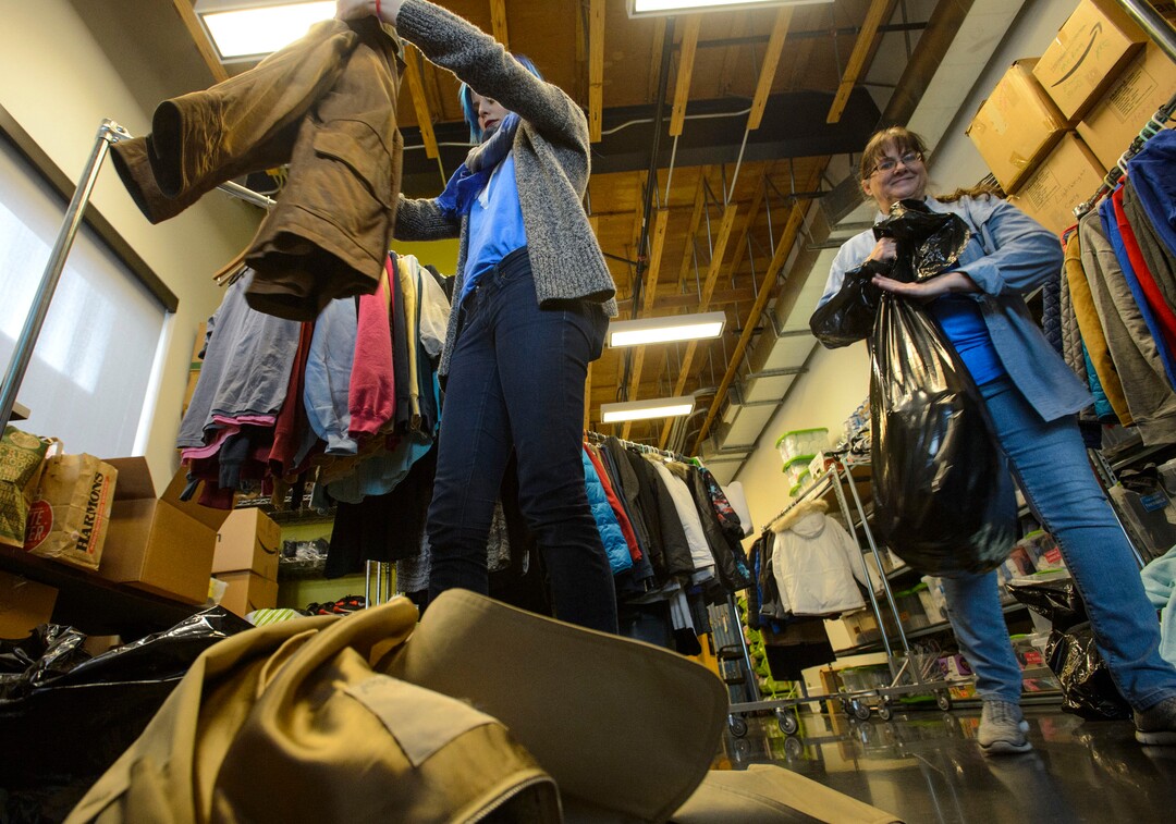 (Steve Griffin  |  The Salt Lake Tribune)  Volunteers  Natalie Bagnell and De Buchanan sort clothing that has been donated to help homeless young people at Volunteers of America,  in Salt Lake City Monday December 11, 2017.