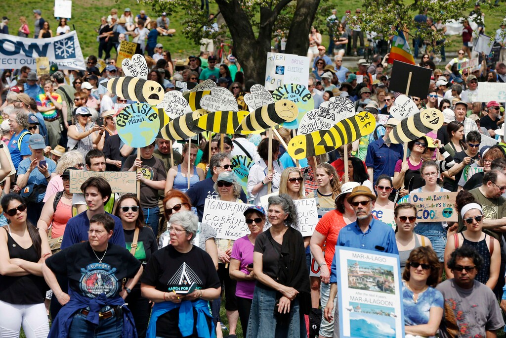 People gather for a climate rally on Boston Common in Boston, Saturday, April 29, 2017. Organizers say they’re marking President Donald Trump’s first 100 days in office by protesting his agenda so far. (AP Photo/Michael Dwyer)