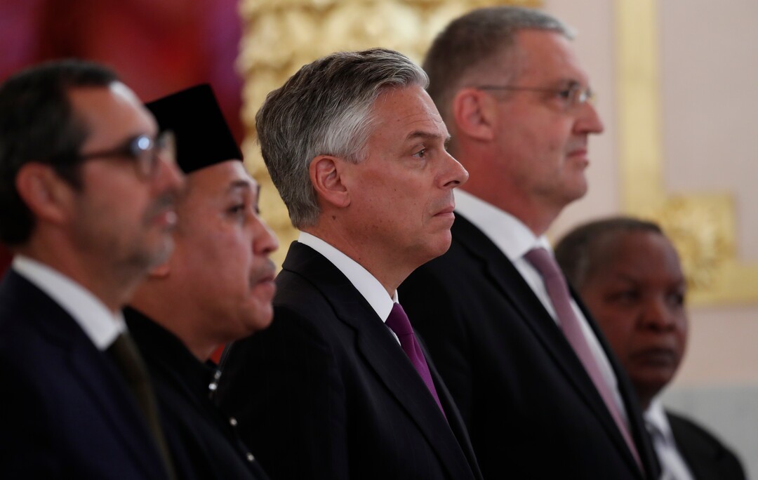 U.S. Ambassador, Jon Huntsman, centre, stands after presenting credentials to Russian President Vladimir Putin during a ceremony in the Kremlin in Moscow, Russia, on Tuesday, Oct. 3, 2017. The new U.S. ambassador to Russia presented his credentials to President Vladimir Putin in the Kremlin on Monday amid investigations into Moscow's meddling in the 2016 U.S. elections. (AP Photo/Pavel Golovkin, Pool)