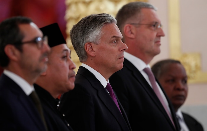 U.S. Ambassador, Jon Huntsman, centre, stands after presenting credentials to Russian President Vladimir Putin during a ceremony in the Kremlin in Moscow, Russia, on Tuesday, Oct. 3, 2017. The new U.S. ambassador to Russia presented his credentials to President Vladimir Putin in the Kremlin on Monday amid investigations into Moscow's meddling in the 2016 U.S. elections. (AP Photo/Pavel Golovkin, Pool)