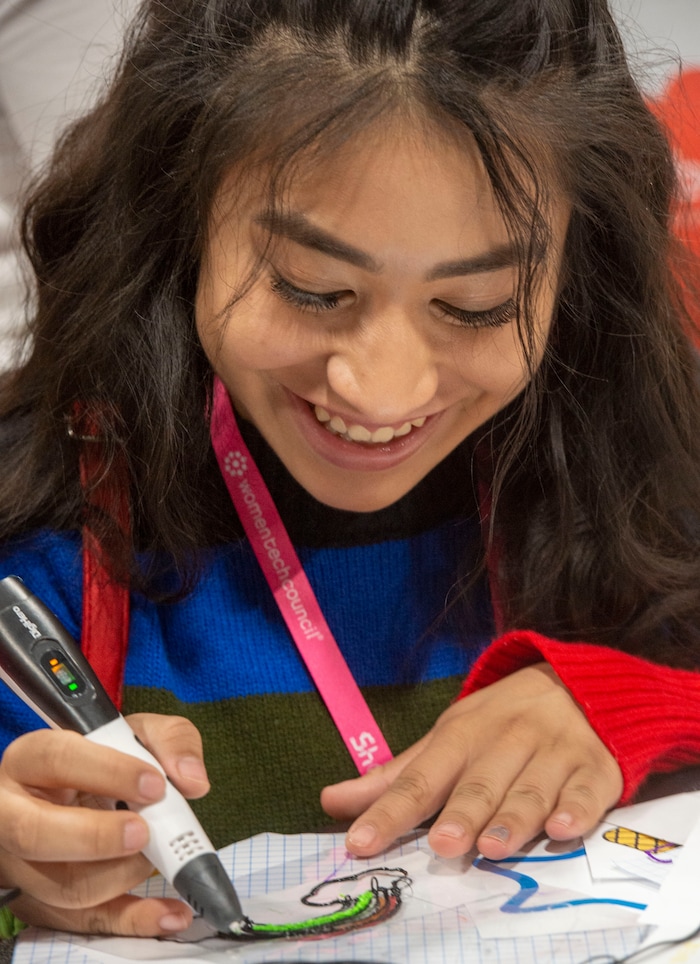(Rick Egan  |  The Salt Lake Tribune)         Emma Newby, from Mountain View High,  checks out the robotic cars at the SheTech Explorer Day event, at the Mountain America Expo Center in Sandy, Tuesday, April 9, 2019.