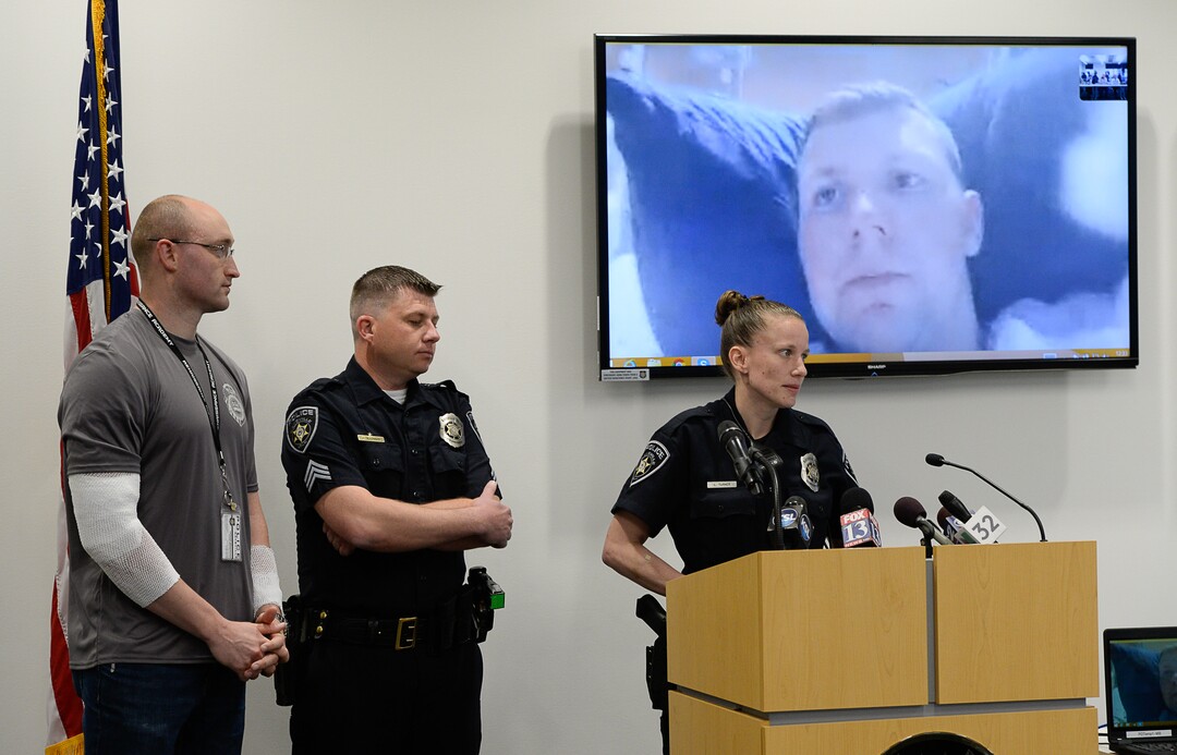 (Francisco Kjolseth  |  The Salt Lake Tribune)  The Kaysville officers that responded to the suicidal subject call on April 5, 2018, and were injured in the fire, speak with the media on Thursday, April 12, 2018. Officer Robert Jackson, 26, recovering at University Hospital burn unit, appears on screen as officer Cade Bradshaw, Sgt. Shawn McKinnon and officer Lacy Turner, from left, answer questions from the media. The four officers were injured when a man at a Chevron gas station store had doused himself with gasoline. As the officers tried to get a lighter from the manÕs hand, the man lit himself on fire.