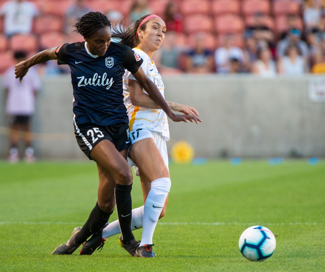(Rick Egan  |  The Salt Lake Tribune)   Seattle Reign FC forward Ifeoma Onumonu (25) goes for the ball along with Utah Royals FC defender Samantha Johnson (16) in soccer action between Utah Royals FC and Seattle Reign FC in Sandy, Friday, June 28, 2019.