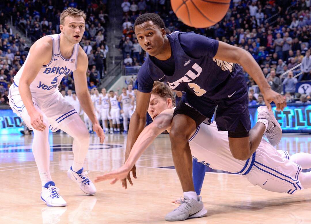 (Leah Hogsten  |  The Salt Lake Tribune) Brigham Young Cougars forward Dalton Nixon (33) hits the deck battling Oral Roberts Golden Eagles guard Max Abmas (3) for the rebound. Brigham Young University defeated Oral Roberts, 79-73, Dec. 28, 2019 at the Marriott Center in Provo.