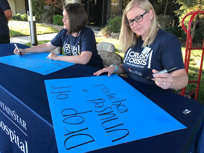 (Courtney Tanner | The Salt Lake Tribune) St. Mark's Hospital volunteers make posters for an opioid and prescription medication drop off event on Saturday, Sept. 7, 2019.