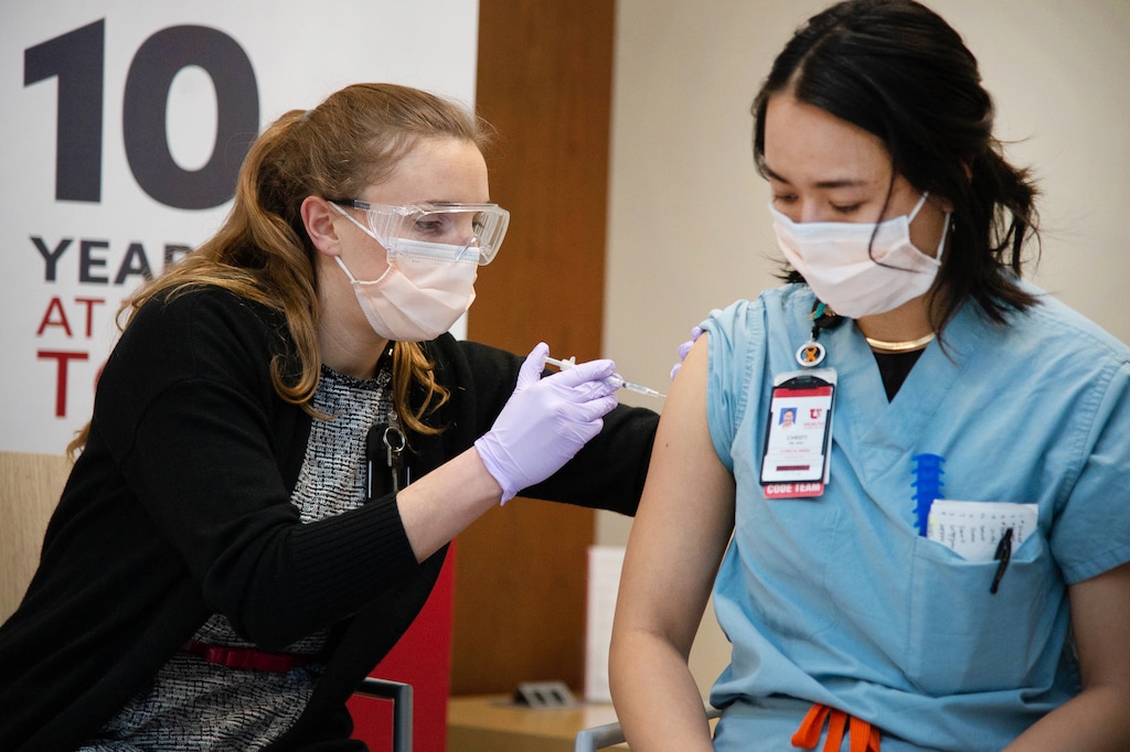 (Francisco Kjolseth  | The Salt Lake Tribune) University of Utah Health begins administering the second dose of the Pfizer-BioNTech COVID-19 vaccine as pharmacy resident Chanah Gallagher gives Christy Mulder, an RN in the MICU, her second dose on Thursday, Jan. 7, 2021.