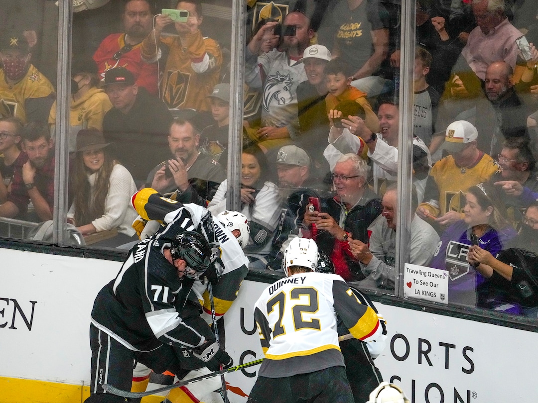 (Leah Hogsten | The Salt Lake Tribune) Fans try to get photos of a scrum as the Los Angeles Kings and Vegas Knights meet in a preseason game at Vivint Arena on Sept. 30, 2021.