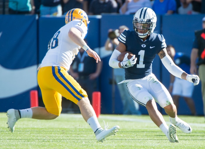(Rick Egan  |  The Salt Lake Tribune)    Brigham Young Cougars defensive back Troy Warner (1) tries to get past McNeese State Cowboys punter Bailey Raborn (38), after picking up a blocked field goal attempt, in football action Brigham Young Cougars vs McNeese State Cowboys at Lavell Edwards Stadium, Saturday, Sept. 22, 2018.


