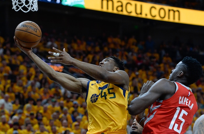 (Francisco Kjolseth | The Salt Lake Tribune) Utah Jazz guard Donovan Mitchell (45) drives past Houston Rockets center Clint Capela (15) in Game 4 of the NBA playoffs at the Vivint Smart Home Arena Sunday, May 6, 2018 in Salt Lake City.