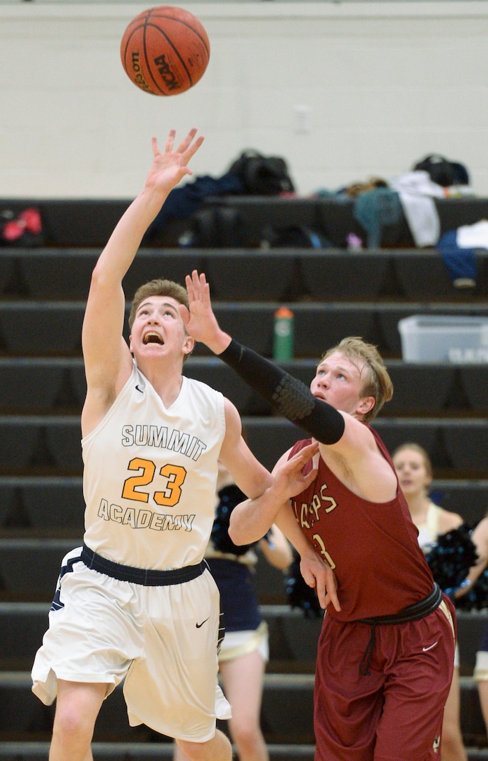 (Leah Hogsten  |  The Salt Lake Tribune) Summit's Edgar Wilson and Juab's Alex White fight for possession. Juab High School boys' basketball team defeated Summit Academy 61-58 during their 3A State tournament game in Heber  Saturday, Feb. 16, 2018.