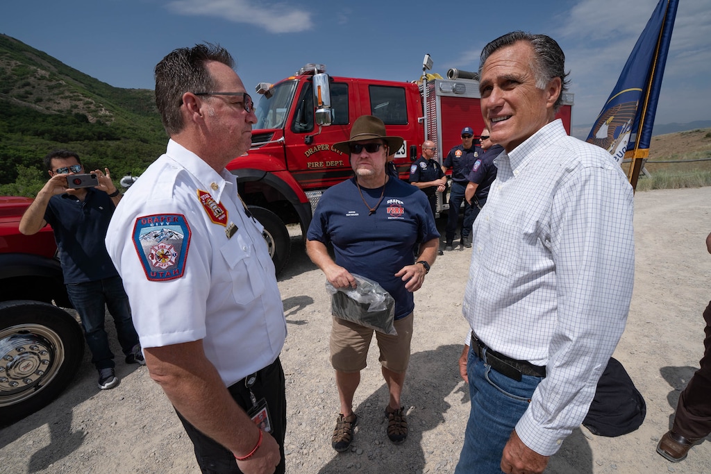 (Francisco Kjolseth | The Salt Lake Tribune) U.S. Sen. Mitt Romney looks up at the hillside homes near Draper as he is joined by Draper Fire Chief Clint Smith, left, and Draper Mayor Troy Walker after an announcement to establish a wildfire commission during a news conference at Little Valley Trailhead in Draper on Friday, June 18, 2021. The commission would conduct a national review of wildfire policy and make recommendations to Congress.