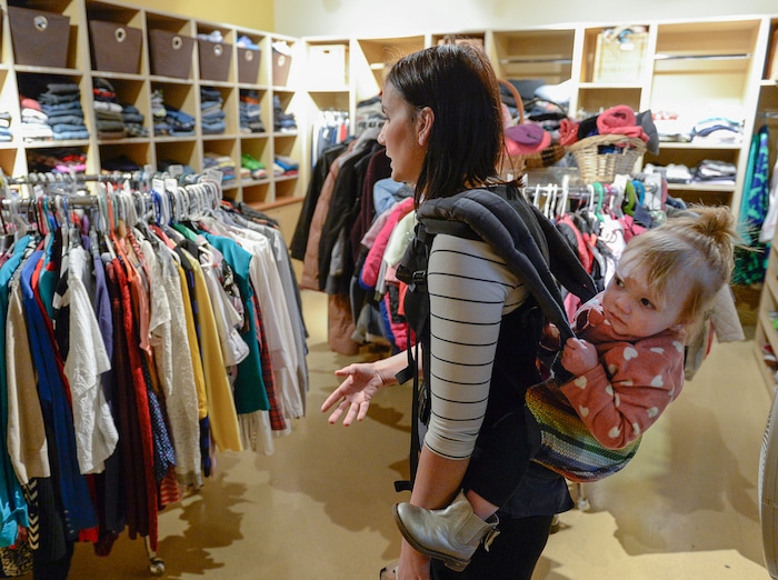 (Francisco Kjolseth | The Salt Lake Tribune) Michelle Densley carries her daughter Eva May, 1, as she describes Betty's Boutique inside the YWCA Center for Women & Families where women who have escaped abuse and often arrive with nothing can pick out clothing for themselves and their children. Densley, a mother of three who lived out of her car and peoples homes for a time feels blessed to have landed an apartment at the women's center after experiencing violent abuse from her former husband during her pregnancy with Eva. Atkinson is encouraging people to donate to the Pamela Atkinson Homeless Trust Fund through their tax forms.