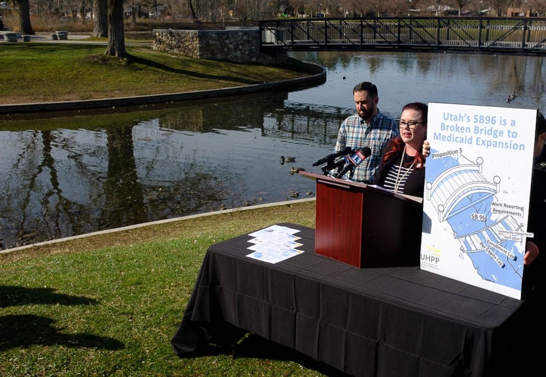 (Trent Nelson | The Salt Lake Tribune)  Stacy Sanford, health policy analyst for the Utah Health Policy Project, talks about Utah's "bridge" Medicaid expansion program at a news conference in Salt Lake City's Liberty Park on Monday April 1, 2019. Nate Crippes at left.