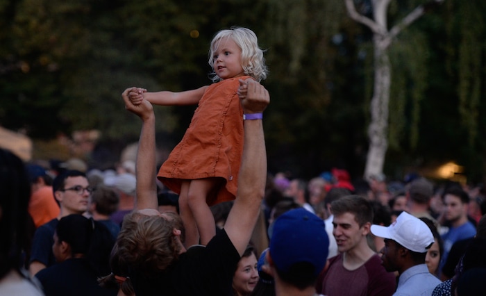 (Francisco Kjolseth | The Salt Lake Tribune) Paul Johnson lifts her daughter Enora, 3, as they enjoy a little down time before The Roots take to the stage for the finale of the 2017 SLC Twilight Concert Series at Pioneer Park on Thursday, Aug. 31, 2017.