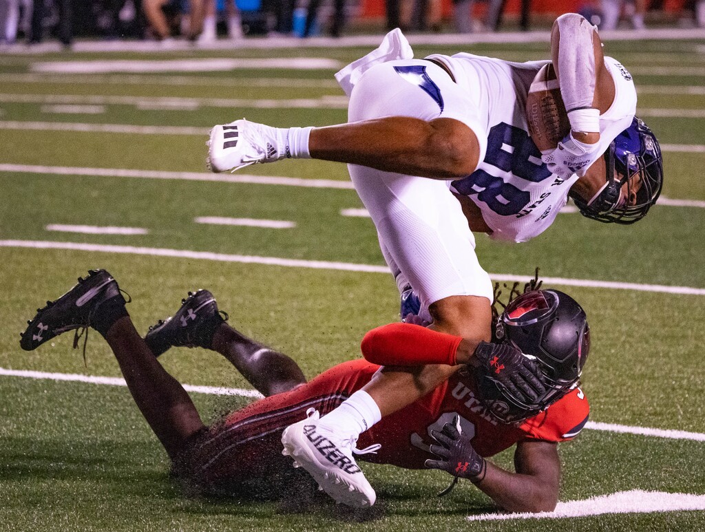 (Francisco Kjolseth | The Salt Lake Tribune) Weber State Wildcats tight end Justin Malone (88) is upended by Utah Utes safety Vonte Davis (9) in PAC-12 football action between the University of Utah and Weber State at Rice-Eccles Stadium on Thursday, Sept. 2, 2021.