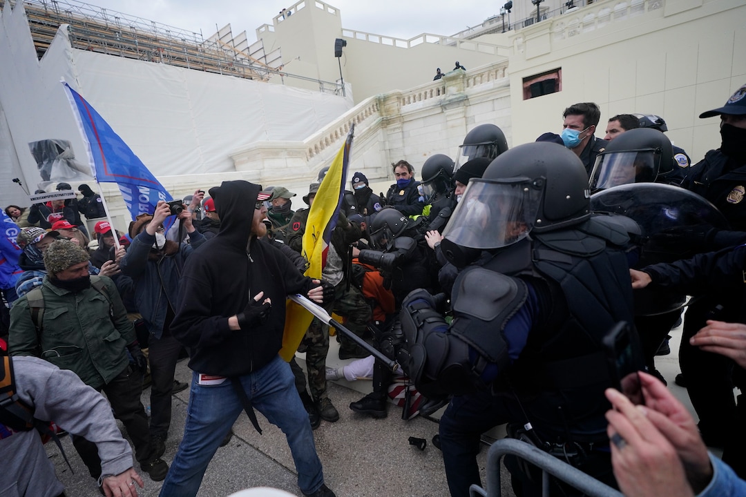Trump supporters try to break through a police barrier, Wednesday, Jan. 6, 2021, at the Capitol in Washington. As Congress prepares to affirm President-elect Joe Biden's victory, thousands of people have gathered to show their support for President Donald Trump and his claims of election fraud. (AP Photo/Julio Cortez)