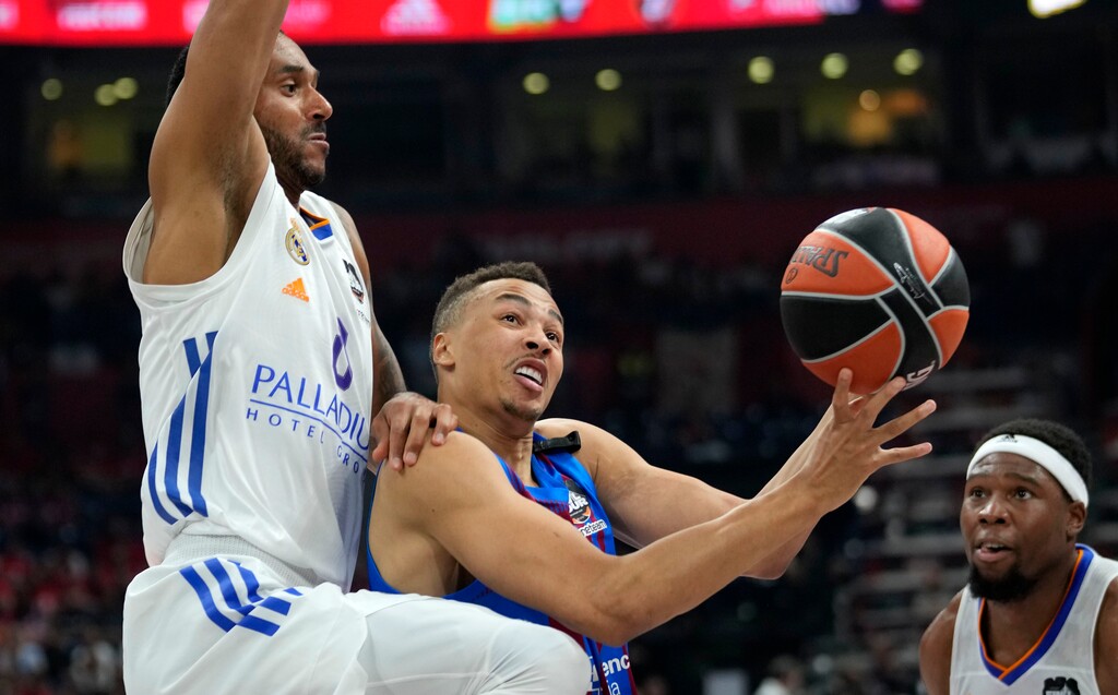 Barcelona's Dante Liman Exum, right drives to the basket challenged by Real Madrid's Adam Hanga during a Final Four Euroleague semifinal basketball match between Barcelona and Real Madrid, in Belgrade, Serbia, Thursday, May 19, 2022. After two seasons playing in Europe, Exum is joining the Dallas Mavericks. (AP Photo/Darko Vojinovic)