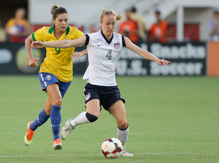 U.S. defender Becky Sauerbrunn (4) moves the ball away from Brazil midfielder Gabi Zanotti (9) during the first half of an international friendly soccer match in Orlando, Fla., Sunday, Nov. 10, 2013.(AP Photo/John Raoux)