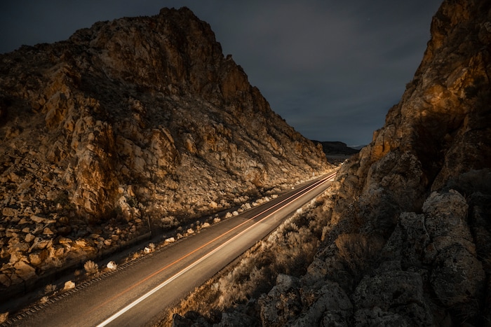 (Leah Hogsten | The Salt Lake Tribune) A car's headlights and break lights illuminate the Parowan Gap, the night before the spring equinox, Mar. 19, 2021. According to the Utah Geological Survey, the Parowan Gap, formed millions of years ago is a classic example of a wind gap, where an ancient river cut a 600-foot deep notch through the Navajo Sandstone of the Red Hills. The Gap is believed to have the most concentrated collections of petroglyphs in the West, dating back some 5,000 years with over 90 panels featuring some 1,500 figures.
