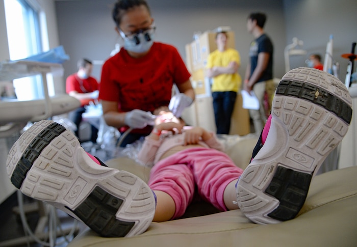(Francisco Kjolseth  |  The Salt Lake Tribune) Sarah Pham, a fourth year dental student at the University of Utah, checks out a young patient as part of the American Dental AssociationÕs ÒGive Kids a SmileÓ program on Saturday, Feb. 29, 2020. The effort launched in 2003 and gives no-cost care to thousands of kids nationwide.