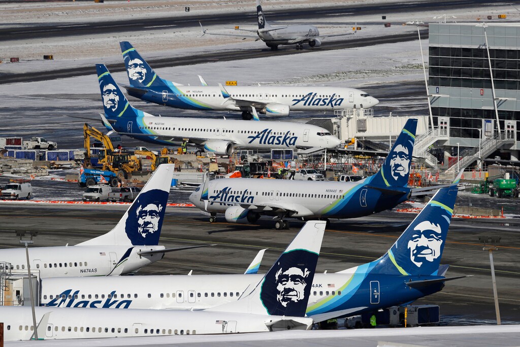 (Ted S. Warren | AP file photo) In this Feb. 5, 2019, file photo, Alaska Airlines planes are parked at a gate area at Seattle-Tacoma International Airport in Seattle. Alaska Airlines said over 300 employees among the company's workforce in Anchorage may lose their jobs on Oct. 1, 2020. The company said the Anchorage layoffs are part of company-wide job cuts because of the economic fallout from the coronavirus pandemic, Alaska Public Media reported Tuesday, Aug. 4.