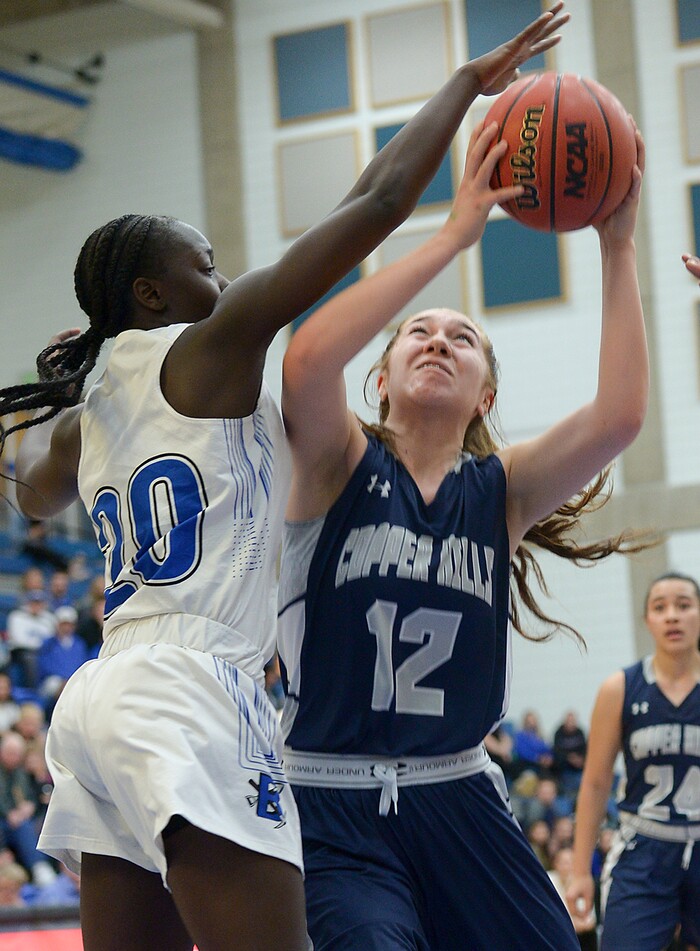 (Leah Hogsten  |  The Salt Lake Tribune)  Copper Hills' Taela Laufiso (12) battles Bingham's Shanyce Makuei (20). Bingham defeated Copper Hills 48-40 in their semifinal game of the 6A High School Girls' Basketball Tournament at SLCC in Taylorsville, Friday, Feb. 23, 2018. 