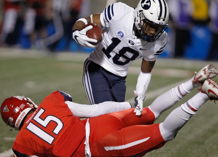 BYU's Michael Shelton tires to avoid Fresno State's Arron Mosby during the first half of an NCAA college football game in Fresno, Calif., Saturday, Nov. 4, 2017. (AP Photo/Gary Kazanjian)