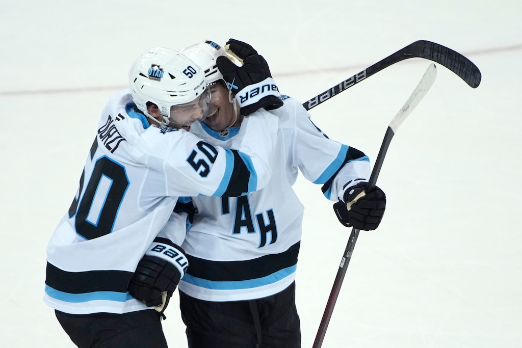 Utah Hockey Club's Sean Durzi, left, and Clayton Keller, right, react after Keller scored the winning goal during overtime of an NHL hockey game against the New York Rangers, Saturday, Oct. 12, 2024, in New York. (AP Photo/Pamela Smith)
