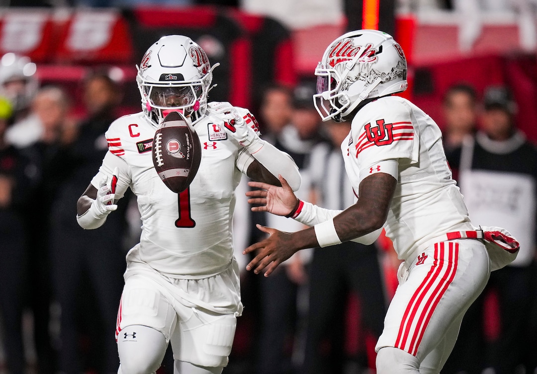 (Bethany Baker  |  The Salt Lake Tribune) Utah Utes quarterback Devon Dampier (4) hands off the ball to Utah Utes running back Wayshawn Parker (1) during the game between the Utah Utes and the Kansas Jayhawks at Rice-Eccles Stadium in Salt Lake City on Saturday, Oct. 10, 2026.