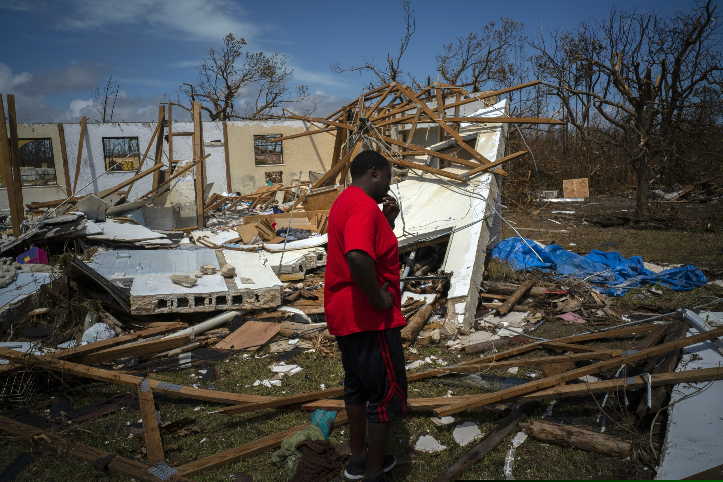 A man cries after discovering his shattered house and not knowing anything about his 8 relatives who lived in the house, missing in the aftermath of Hurricane Dorian, in High Rock, Grand Bahama, Bahamas, Thursday Sept. 5, 2019. (AP Photo/Ramon Espinosa)