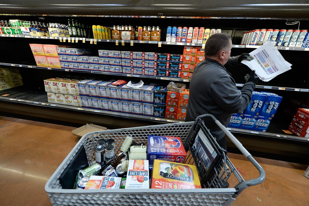 (Francisco Kjolseth | The Salt Lake Tribune) Distribution crews fill the shelves at Smith's Food and Drug in Woods Cross, Utah with beer that is 5% alcohol by volume on Friday, Nov. 1, 2019, for the first time in 86 years, as the former 3.2% beer is put in a cart for removal.