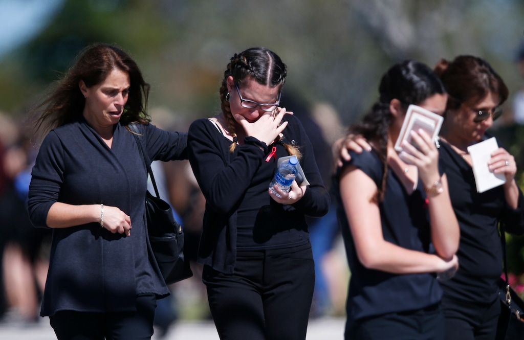 Family and friends console each other as they attend a funeral service for Alyssa Alhadeff at the Star of David Funeral Chapel in North Lauderdale, Fla., Friday, Feb. 16, 2018.  Alhadeff was one of the victims of Wednesday shooting at Marjory Stoneman Douglas High School.  Nikolas Cruz, a former student, was charged with 17 counts of premeditated murder.  (AP Photo/Brynn Anderson)