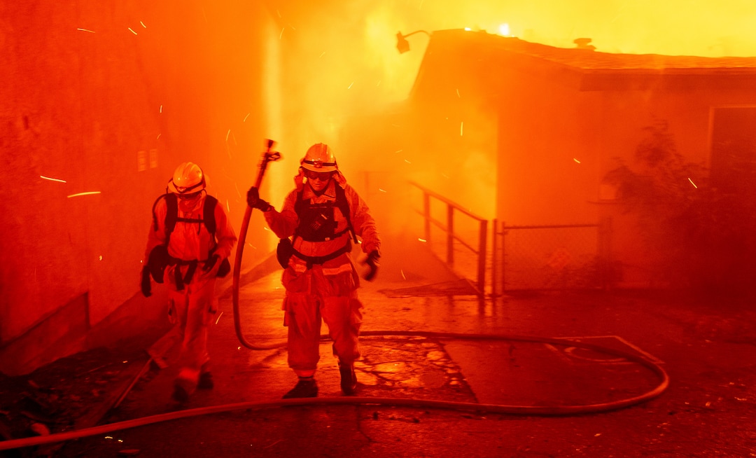 (Noah Berger | The Associated Press) Firefighters battle the Camp Fire as it tears through Paradise, Calif., on Thursday, Nov. 8, 2018. Tens of thousands of people fled a fast-moving wildfire Thursday in Northern California, some clutching babies and pets as they abandoned vehicles and struck out on foot ahead of the flames that forced the evacuation of an entire town and destroyed hundreds of structures.