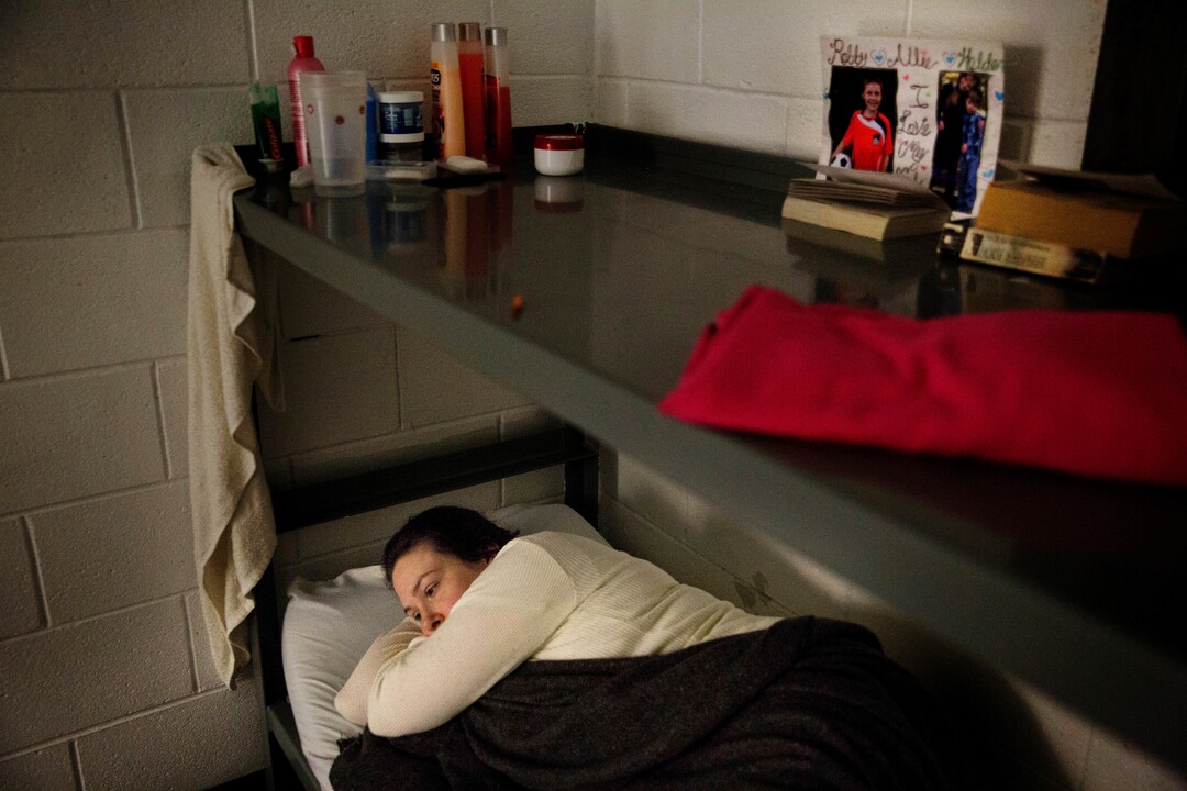 ADVANCE FOR USE MONDAY, MAY 21, 2018 AND THEREAFTER-Inmate Krystle Sweat lays in bed before falling asleep in her cell at the Campbell County Jail in Jacksboro, Tenn., Monday, April 23, 2018. For years now, she has cycled in and out of jail, arrested more than two dozen times for robbery, driving violations and other crimes _ almost all related to her drug addiction that culminated in a $300-a-day pain pill habit. Sweat's tried to quit, but nothing has worked. Now she says she's ready to make the break when she's paroled again, possibly this summer. "I'm almost 33," she says. "I don't want to continue living like this. I want to be someone my family can count on." (AP Photo/David Goldman)